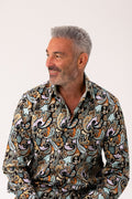 Man wearing a patterned shirt on a white background
