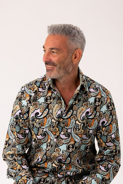 Man wearing a patterned shirt on a white background