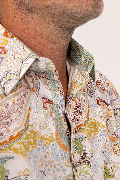 Detail of a paisley pattern mens shirt in beige, mustard and sage.