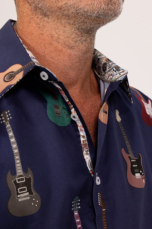 Navy blue shirt with guitar patterns on a plain background