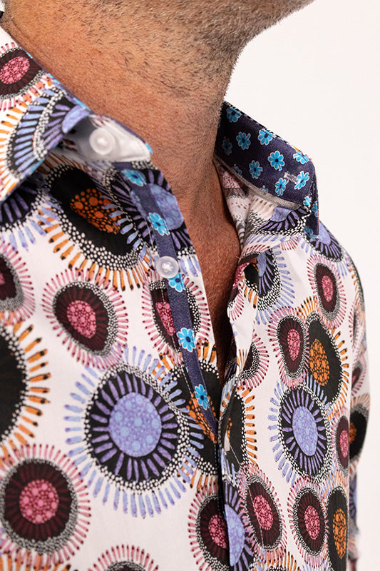 Close-up of a colorful patterned shirt with a white background