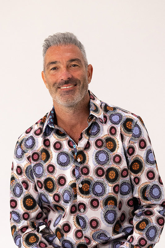 Man wearing a patterned shirt on a white background