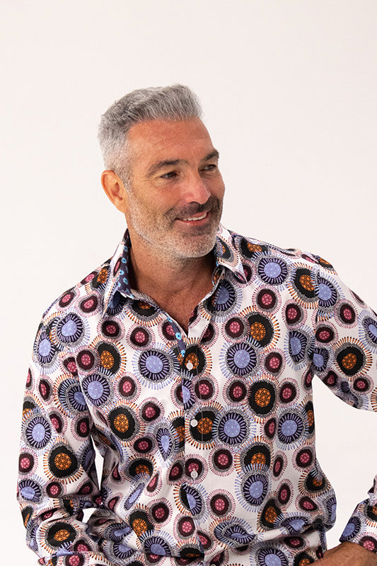 Man wearing a patterned shirt with a white background
