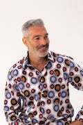 Man wearing a patterned shirt with a white background