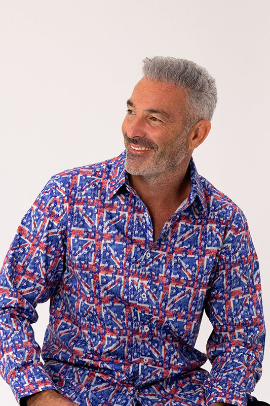 Man wearing a blue and red patterned shirt against a white background