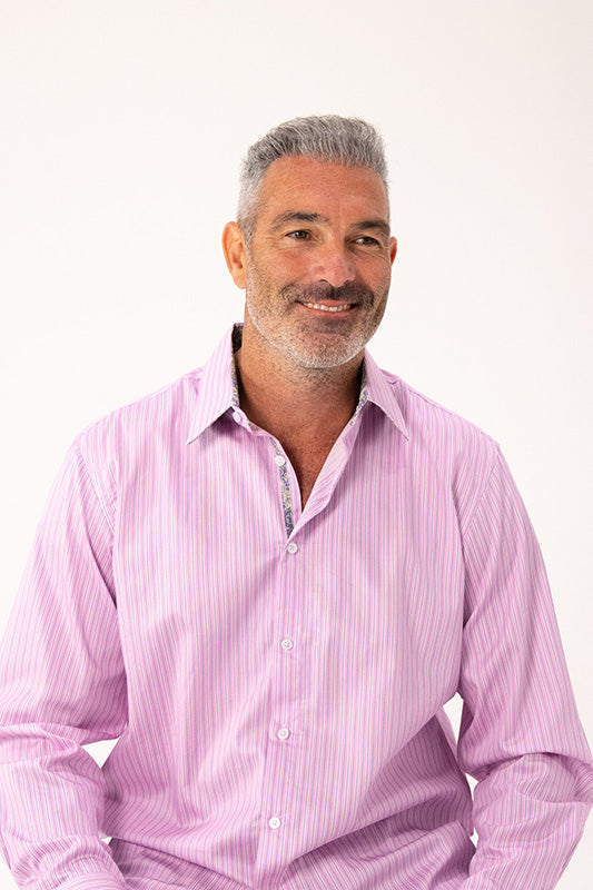 Man wearing a pink striped shirt against a white background