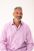 Man wearing a pink striped shirt against a white background