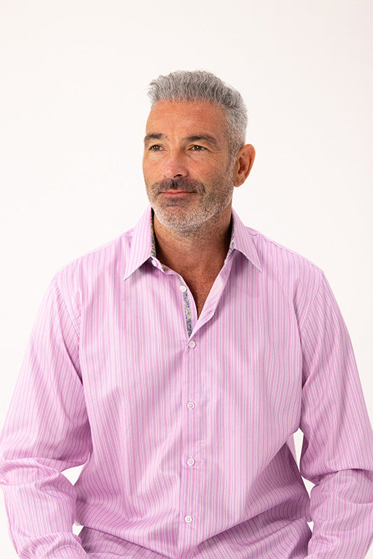 Man wearing a pink striped shirt against a white background