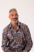 Man wearing a patterned shirt on a white background