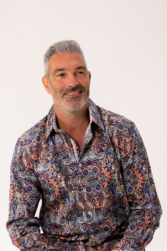 Man wearing a patterned shirt on a white background