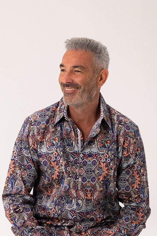 Man wearing a paisley shirt on a white background